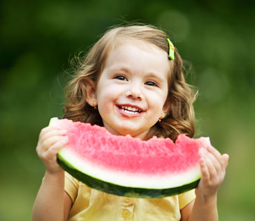 young girl eating watermelon
