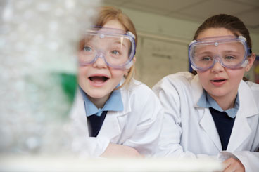 Children wearing safety goggles in a science lab
