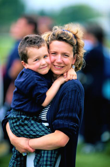 mom holding and hugging early years boy